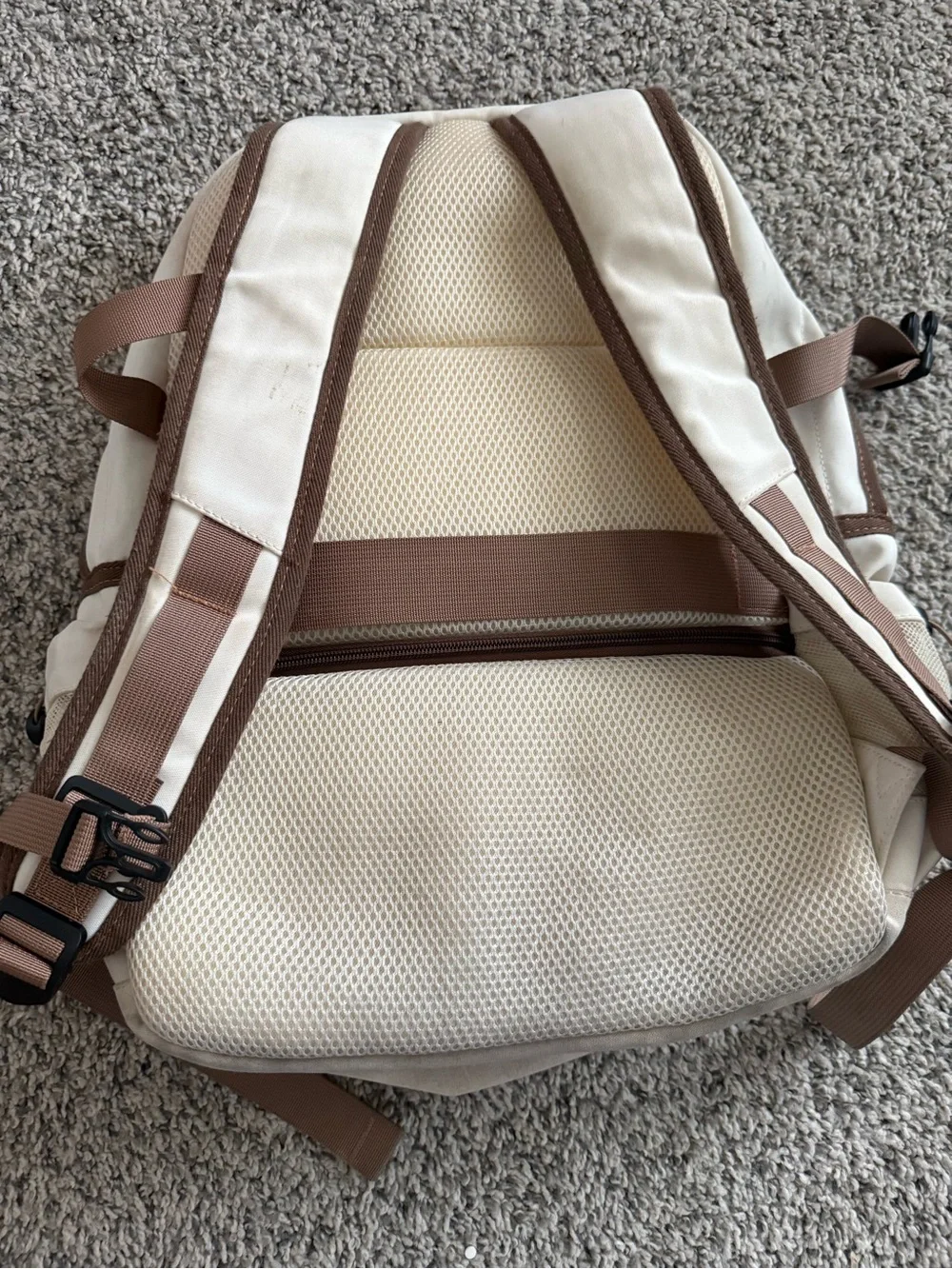 cream and brown colored backpack